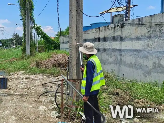 ช่างสำรวจตั้งเสาเครื่องรับ GNSS ที่โคนเสาไฟฟ้า